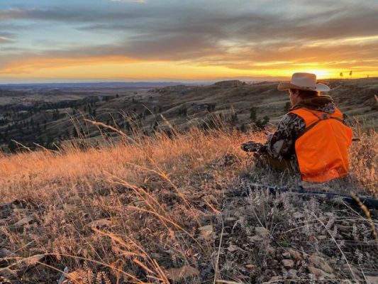 Hunter at sunset on a hillside
