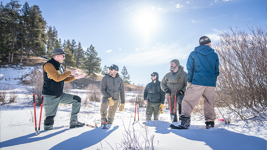 Volunteers engaged in habitat restoration in a snowy environment.