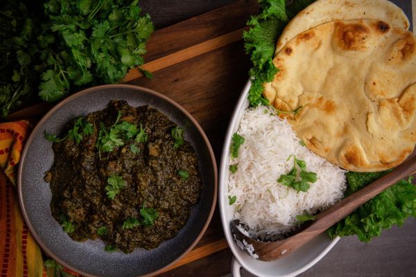 Delicious Indian spinach curry served with rice and naan bread.