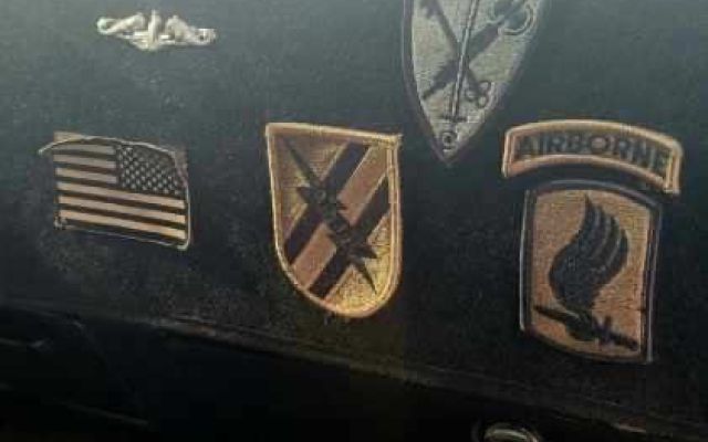 Dashboard display of military patches and insignia.