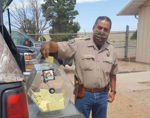 Community event with officer participating in a raffle drawing
