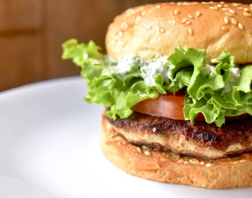 Close-up of a gourmet hamburger with lettuce and tomato