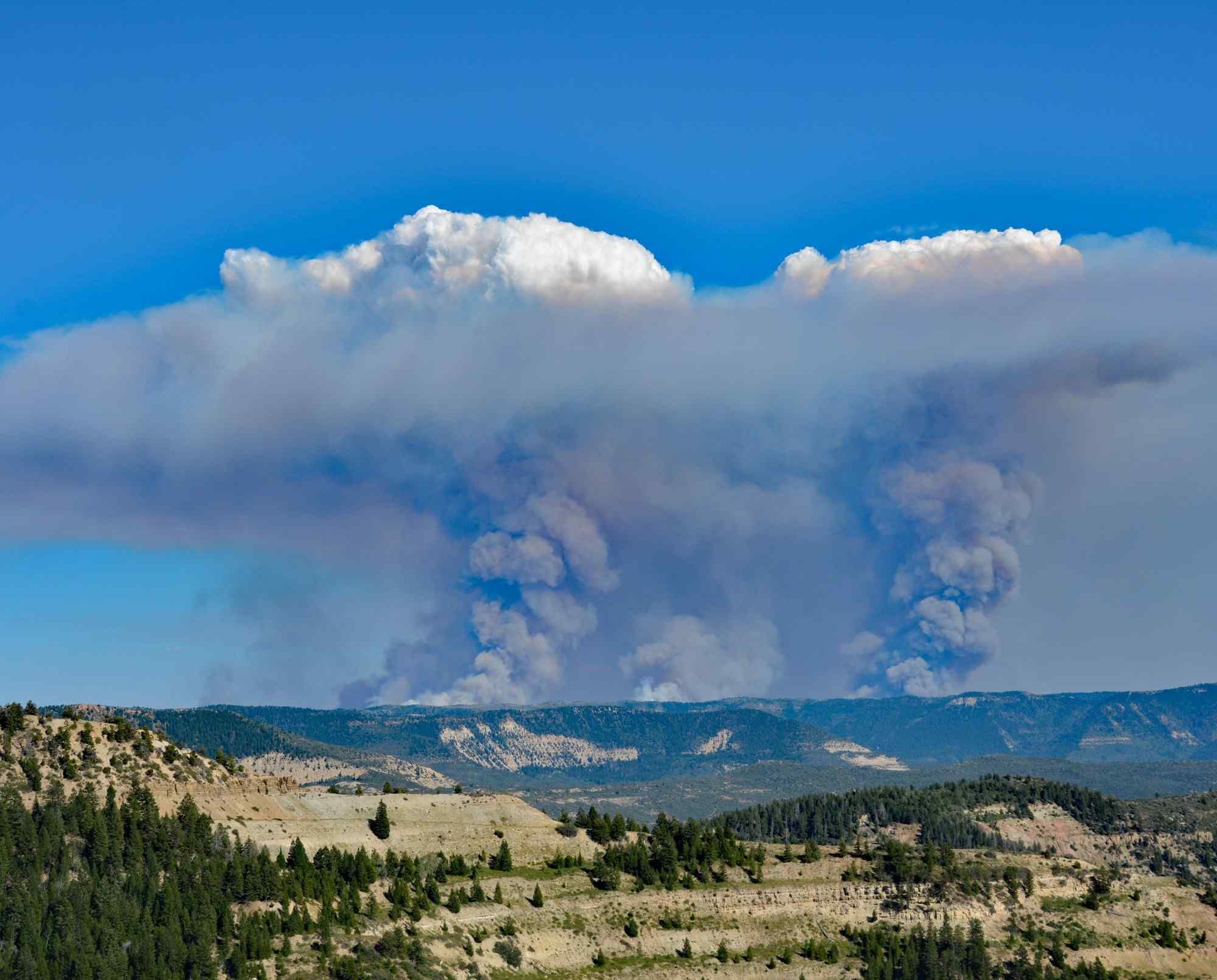 Wildfire smoke billowing over Colorado mountains.