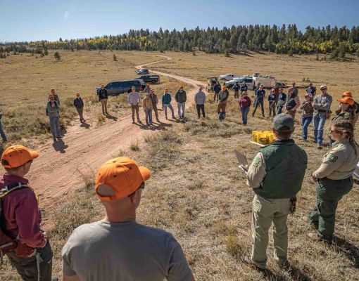 Group of volunteers gathered for habitat restoration meeting.
