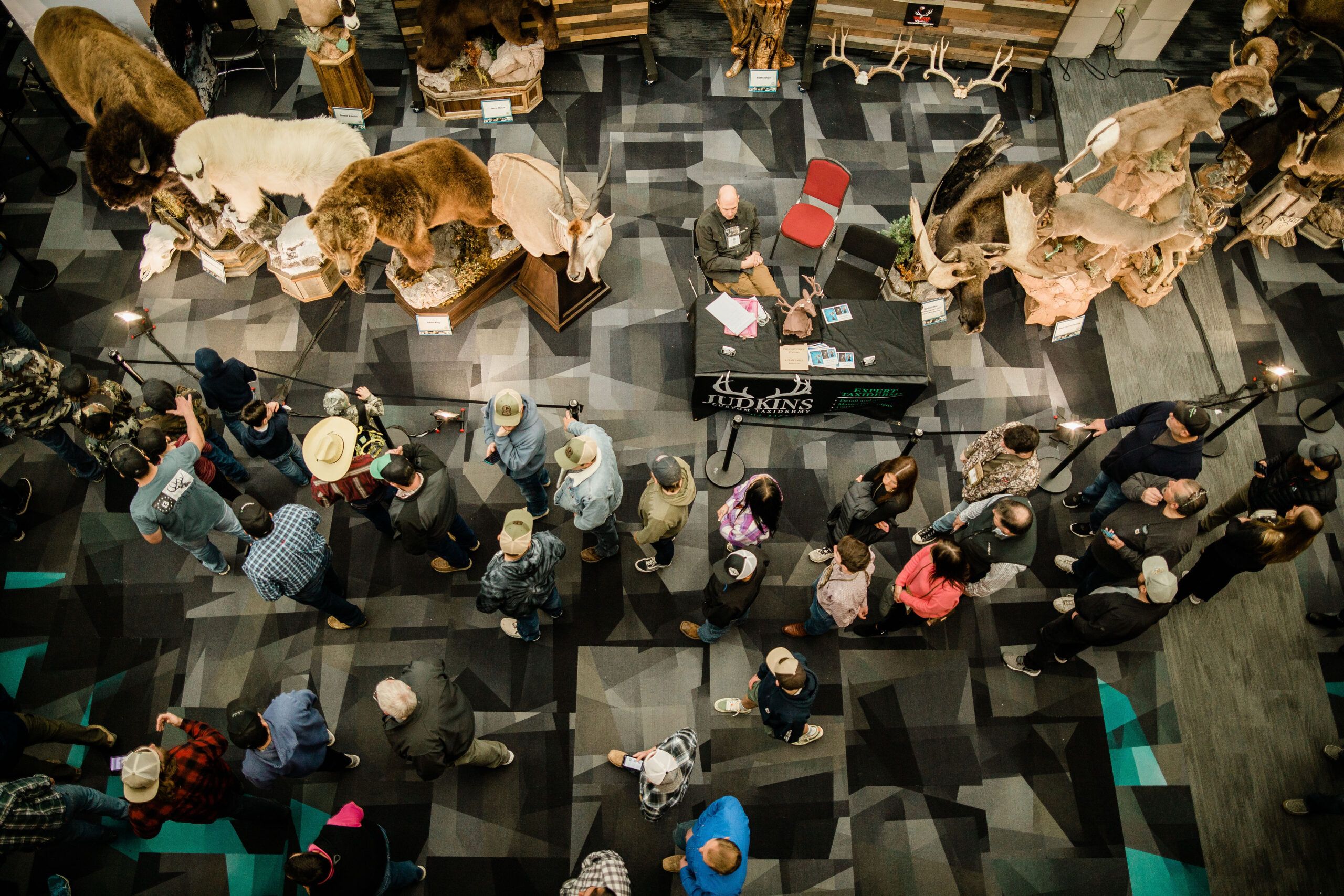 Hunting conservation exhibition featuring taxidermy and attendees