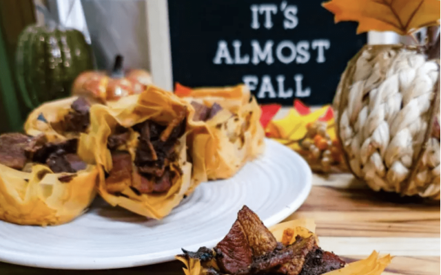 Delicious venison-filled pastry presented with autumn decorations.