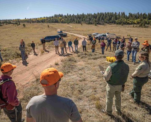 Group of volunteers gathered for habitat restoration meeting.