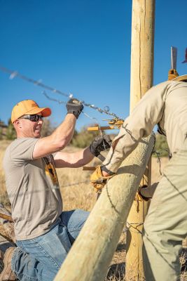 Volunteers working on fence construction for habitat restoration.