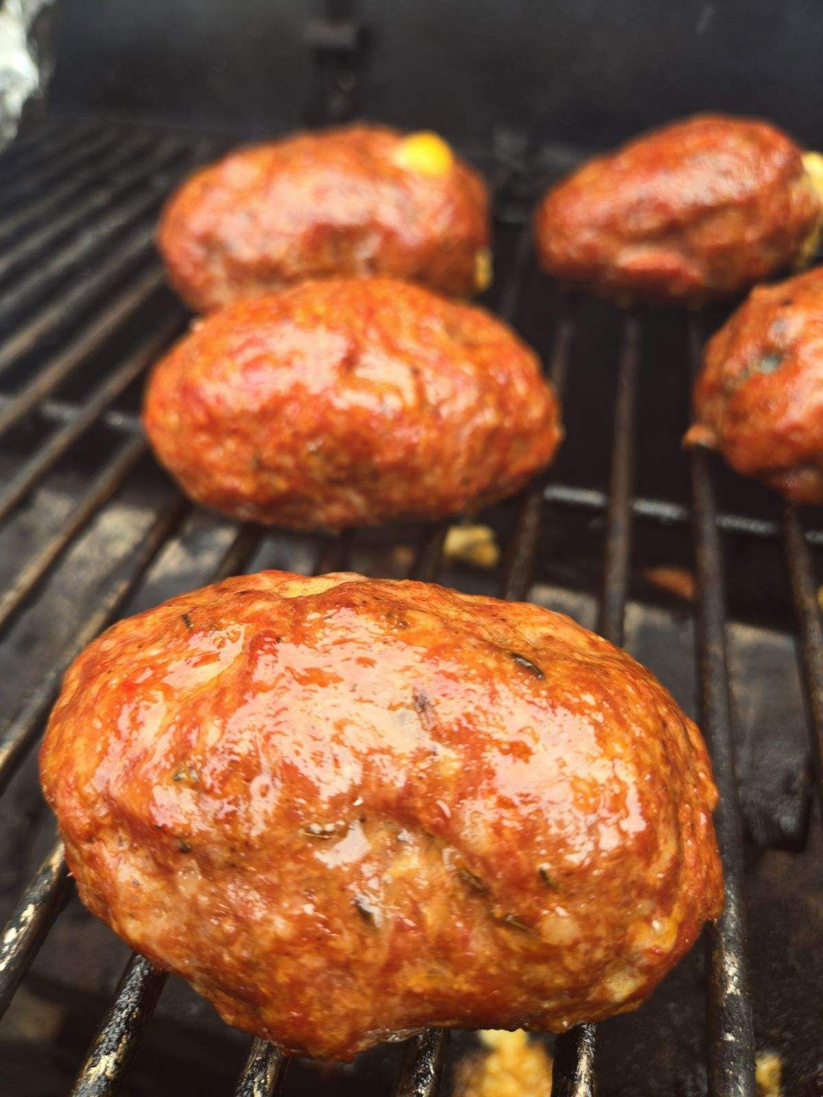 Grilled meatloaf cooking on barbecue grill.