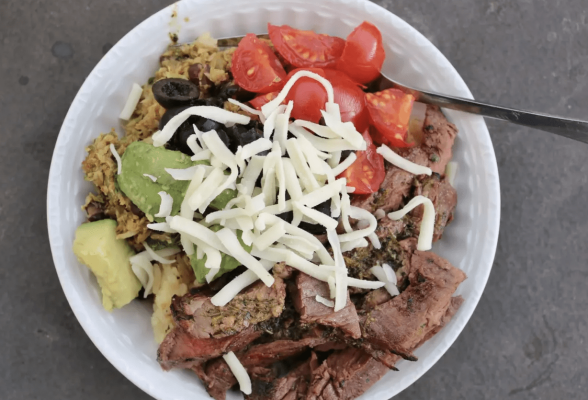 Bowl of food featuring mule deer meat and fresh ingredients.