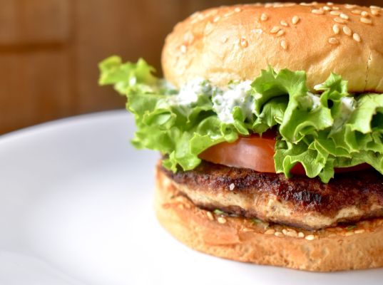Close-up of a gourmet hamburger with lettuce and tomato