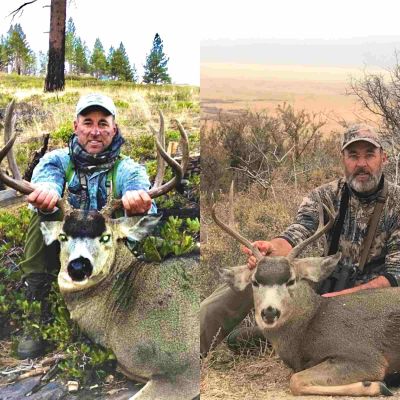 Two hunters posing with trophy mule deer bucks