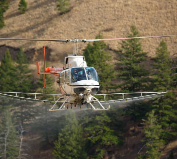 Helicopter assisting in conservation project for revegetation.