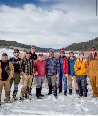 Group of volunteers in snowy conservation area