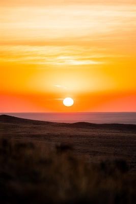 Stunning sunset view over open plains with vibrant colors.