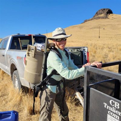 Volunteer in habitat conservation wearing gear outdoors.