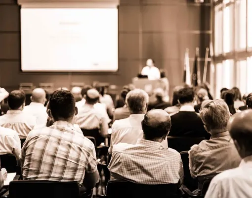 Group of attendees at a conference during a presentation.