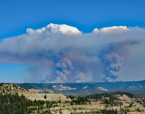 Wildfire smoke billowing over Colorado mountains.