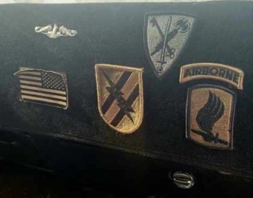 Dashboard display of military patches and insignia.