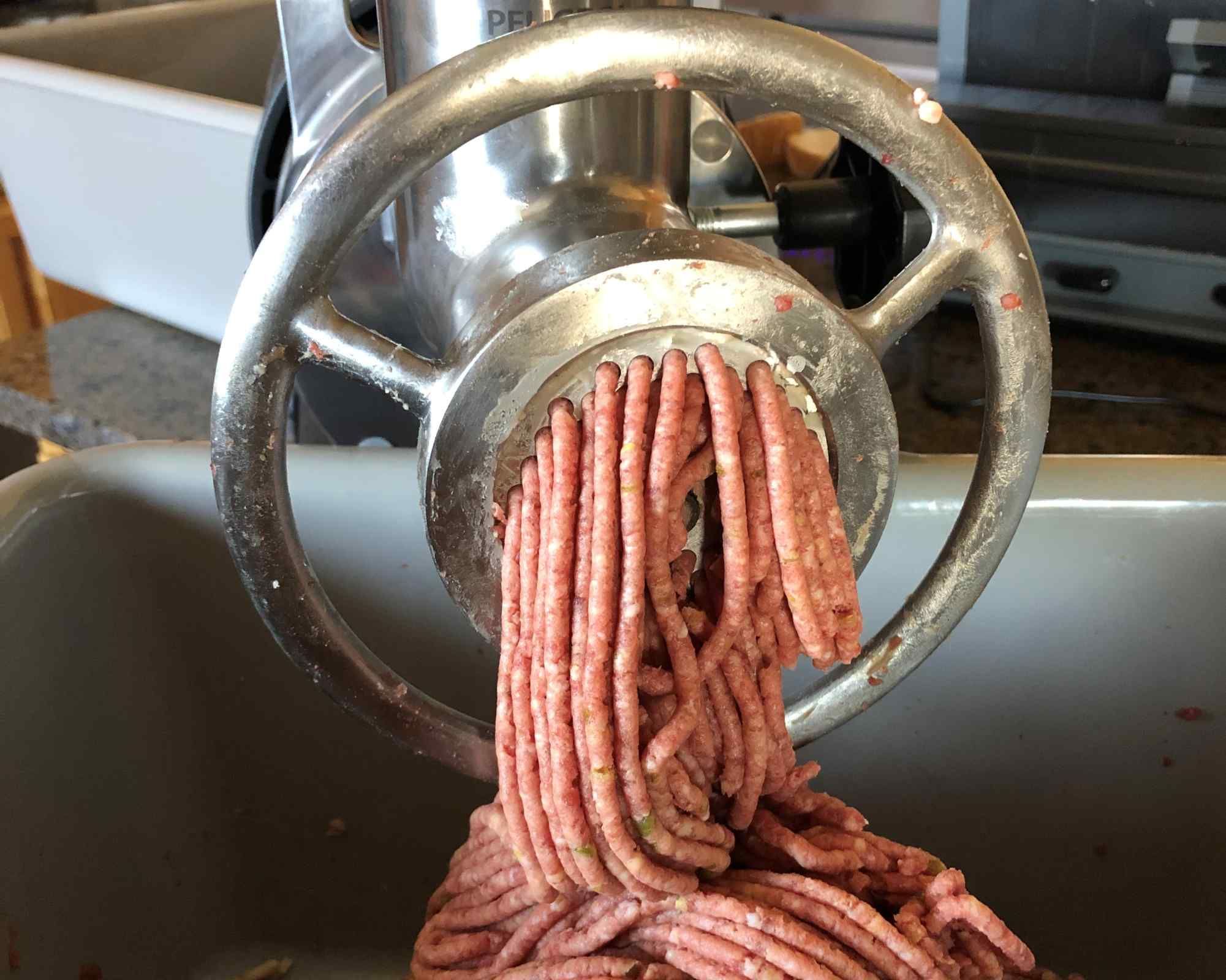 Meat grinder processing ground game meat