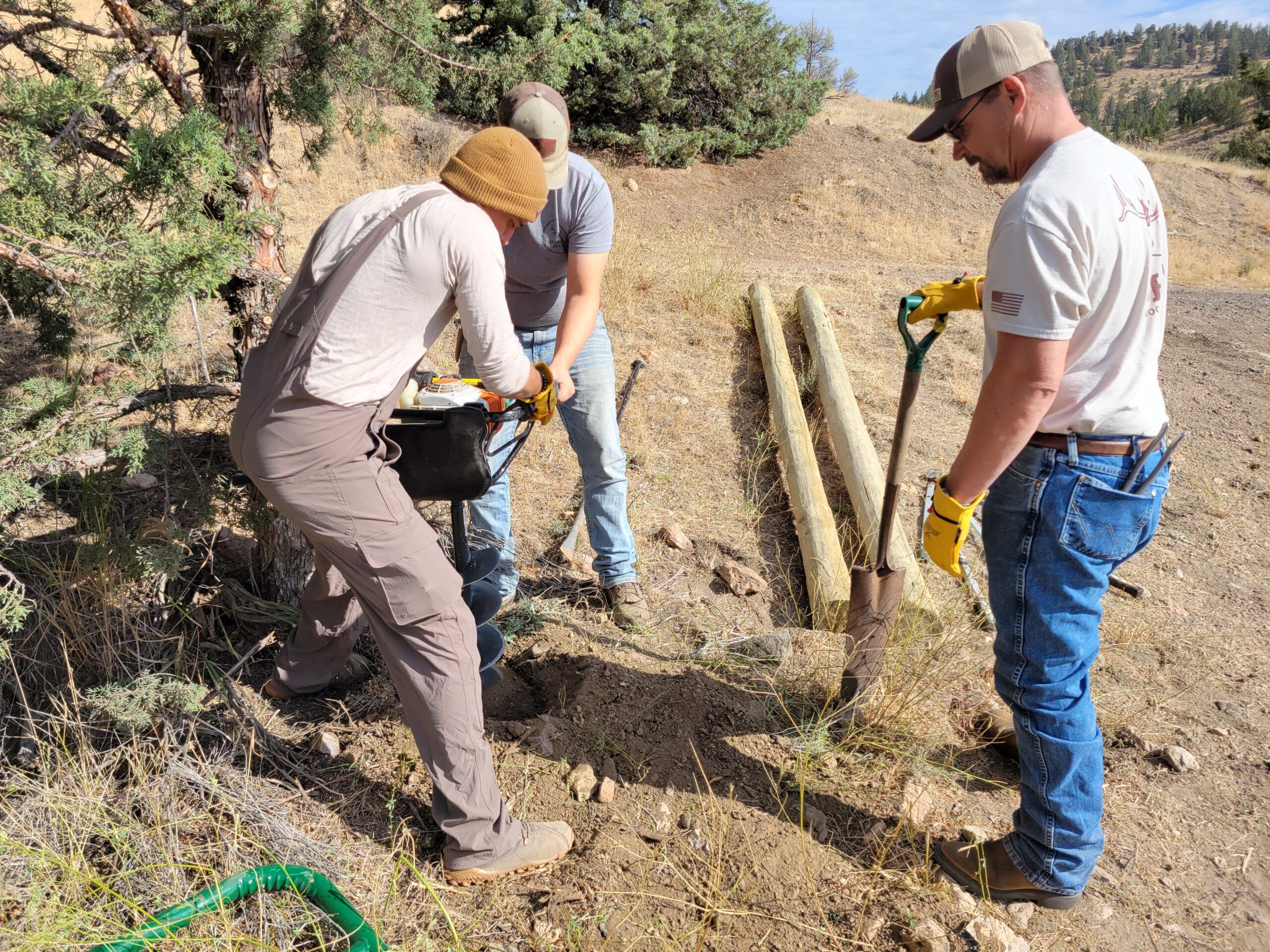Volunteers working on habitat restoration by installing fencing.