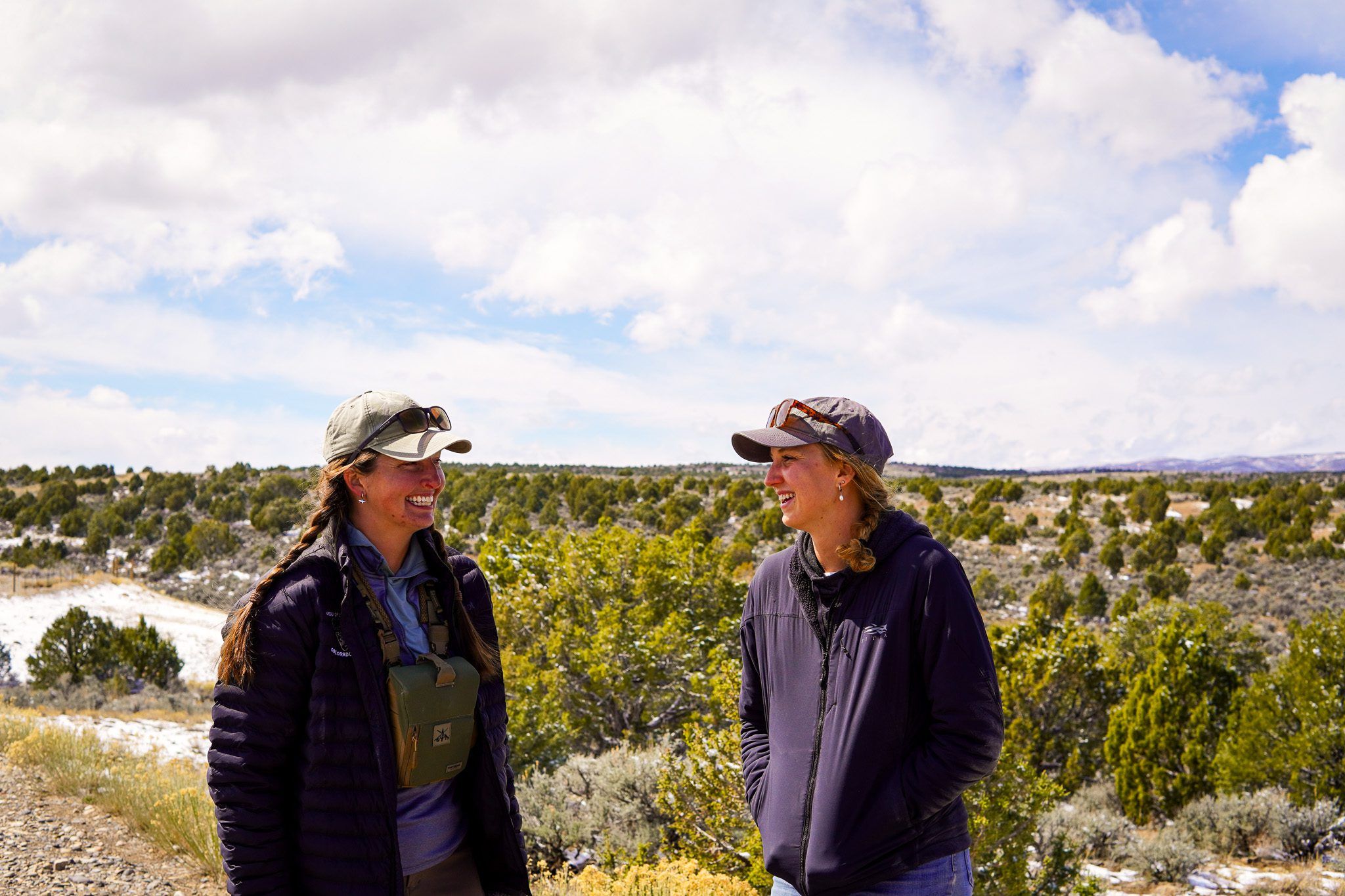 Two women smiling in a conservation planning setting.