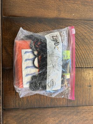Emergency safety kit in a ziplock bag with supplies.