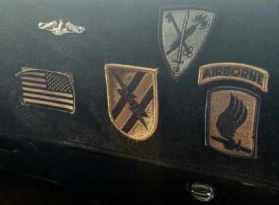 Dashboard display of military patches and insignia.