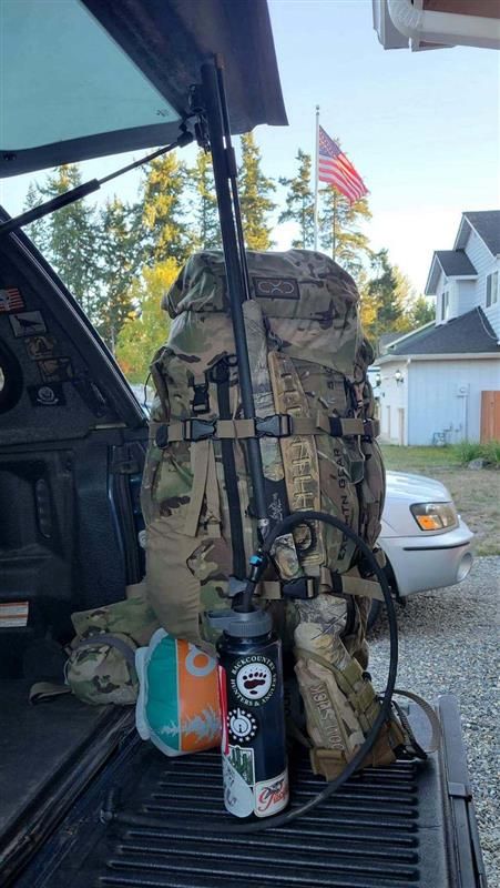 Hunting backpack and water bottle in truck bed