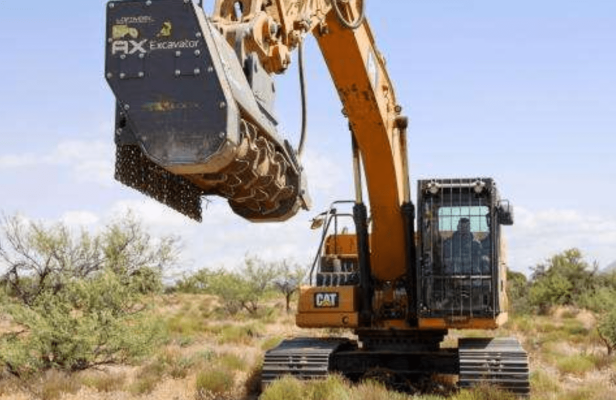 Excavator working in a desert habitat for conservation efforts.