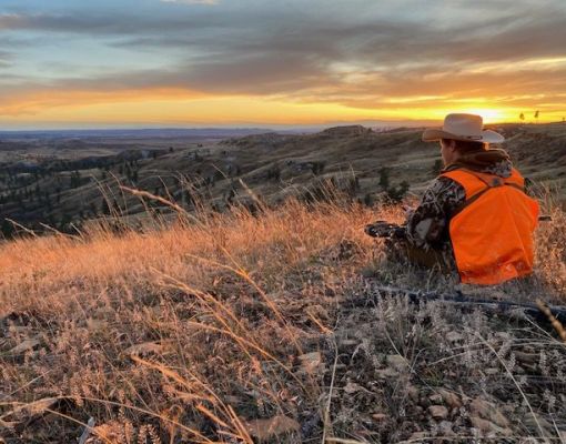 Hunter at sunset on a hillside