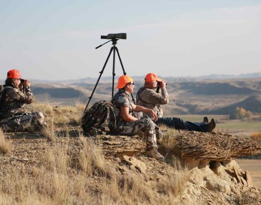 Hunters observing the landscape with binoculars