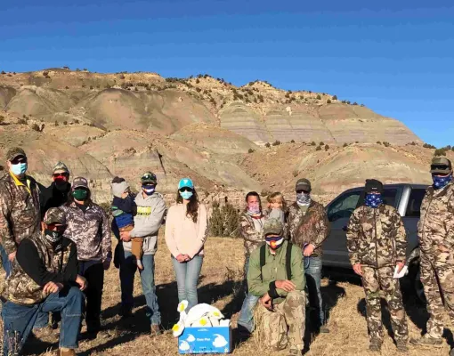 Group of volunteers in a mountainous outdoor setting.