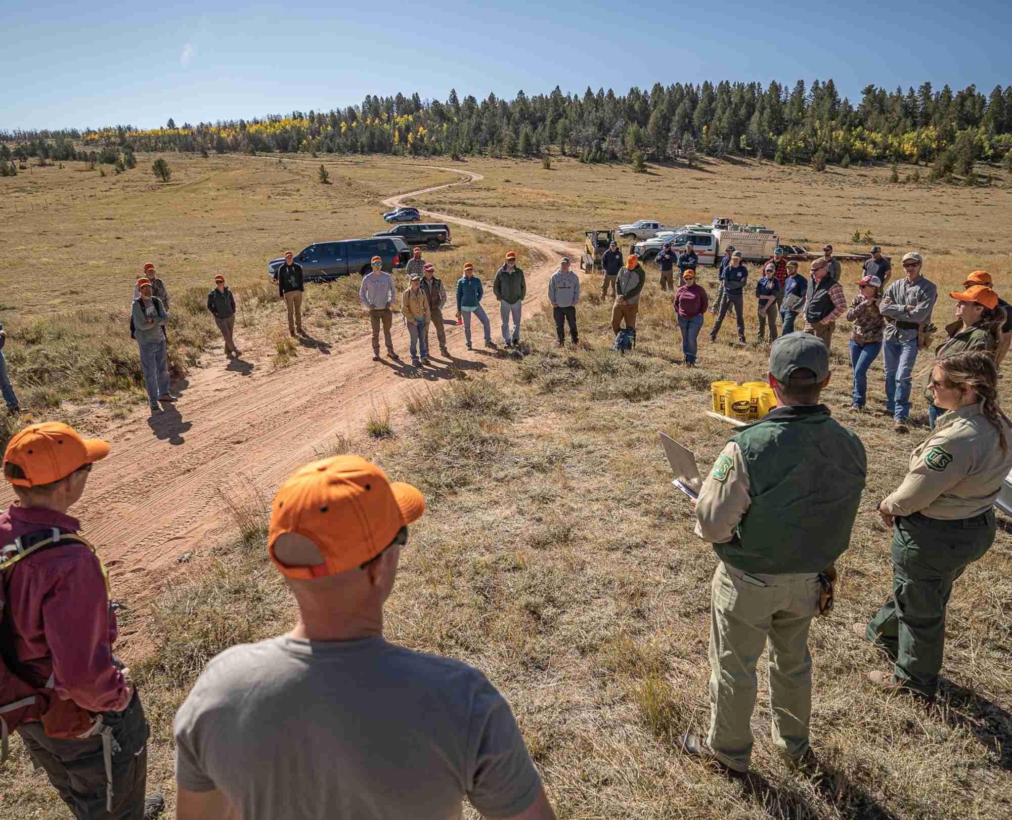 Group of volunteers gathered for habitat restoration meeting.