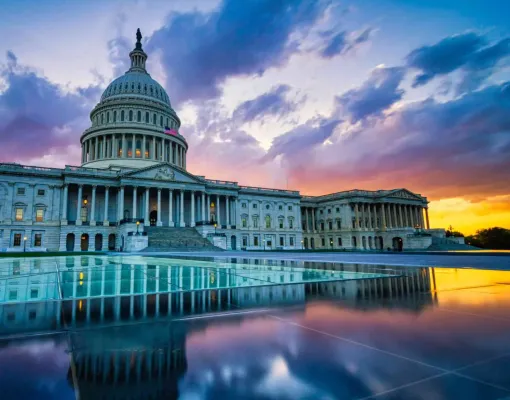 U.S. Capitol Building at sunset with reflections in the foreground