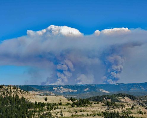 Wildfire smoke billowing over Colorado mountains.