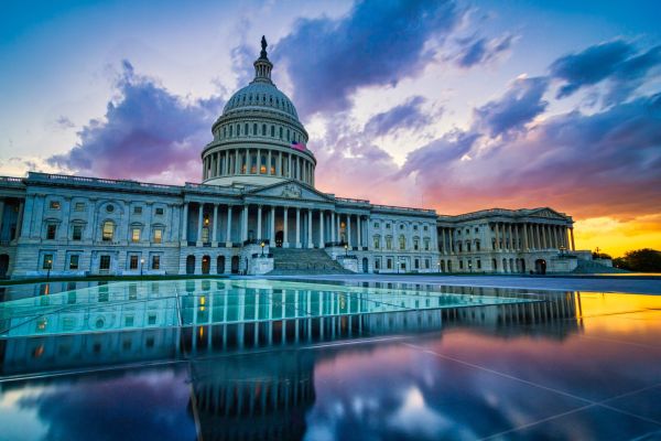 U.S. Capitol building at sunset with reflections