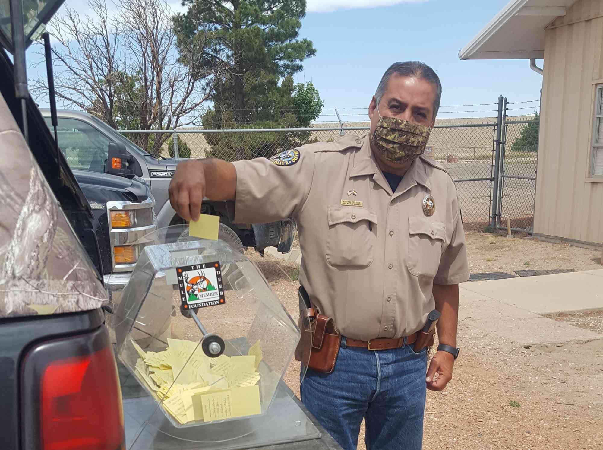 Community event with officer participating in a raffle drawing