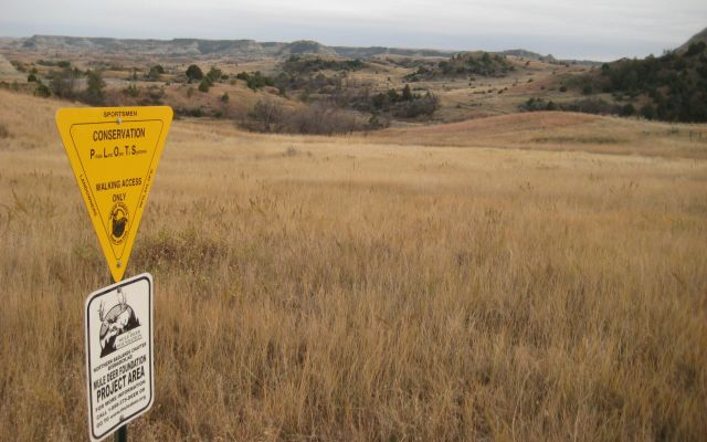 Mule Deer Foundation project area sign in a grassy habitat