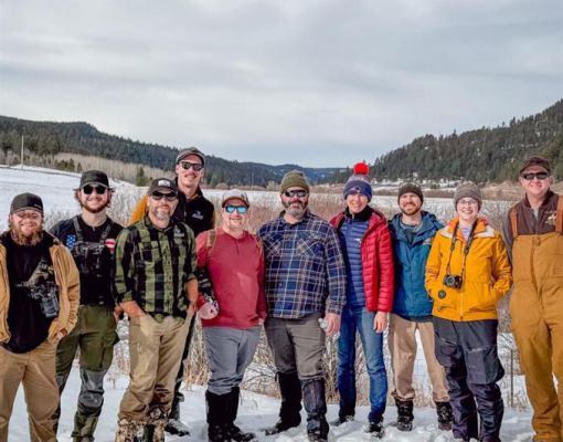 Group of volunteers in snowy conservation area