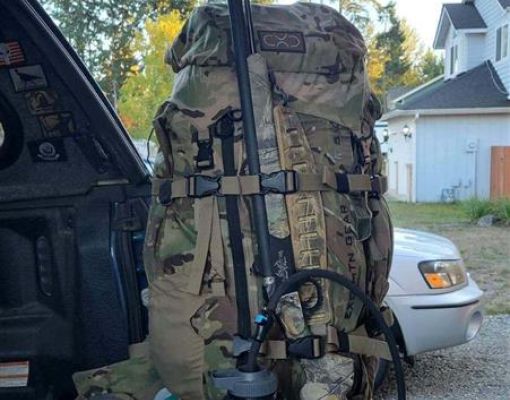 Hunting backpack and water bottle in truck bed