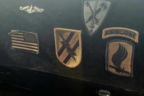 Dashboard display of military patches and insignia.