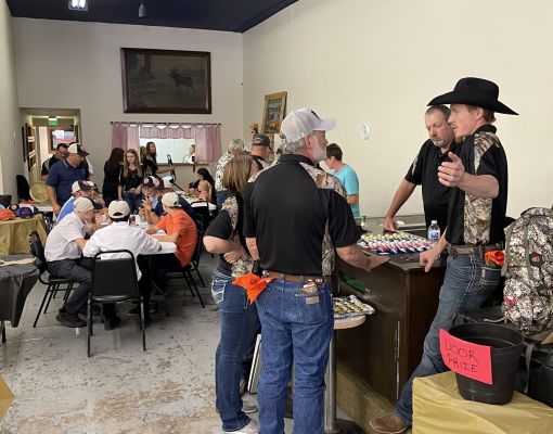 Community gathering at Mule Deer Foundation banquet event with attendees