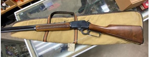 Lever action rifle in a case at a store display.
