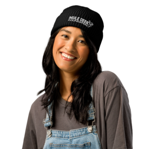 Portrait of a smiling woman wearing a Mule Deer Foundation beanie.