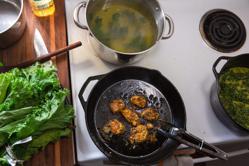 Cooking scene with skillet, soup pot, and fresh ingredients.