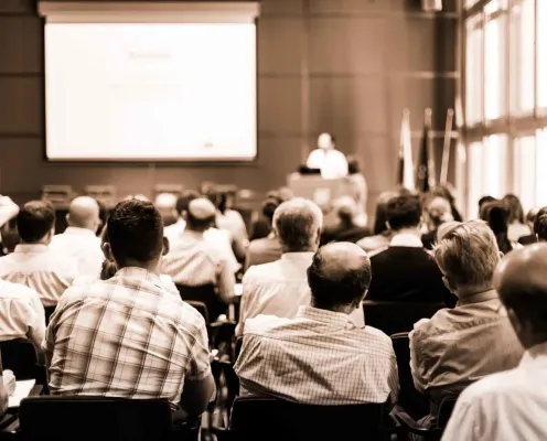Group of attendees at a conference during a presentation.