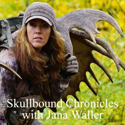 Jana Waller with hunting gear and antlers in the forest