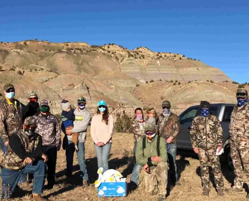 Group of volunteers in a mountainous outdoor setting.
