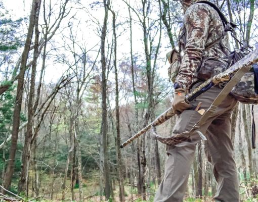Hunter in camouflage observing the woods